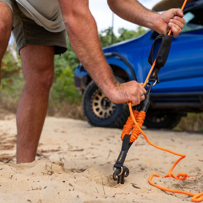 03 Tiegear soft A guy rope is tightened on a beach.