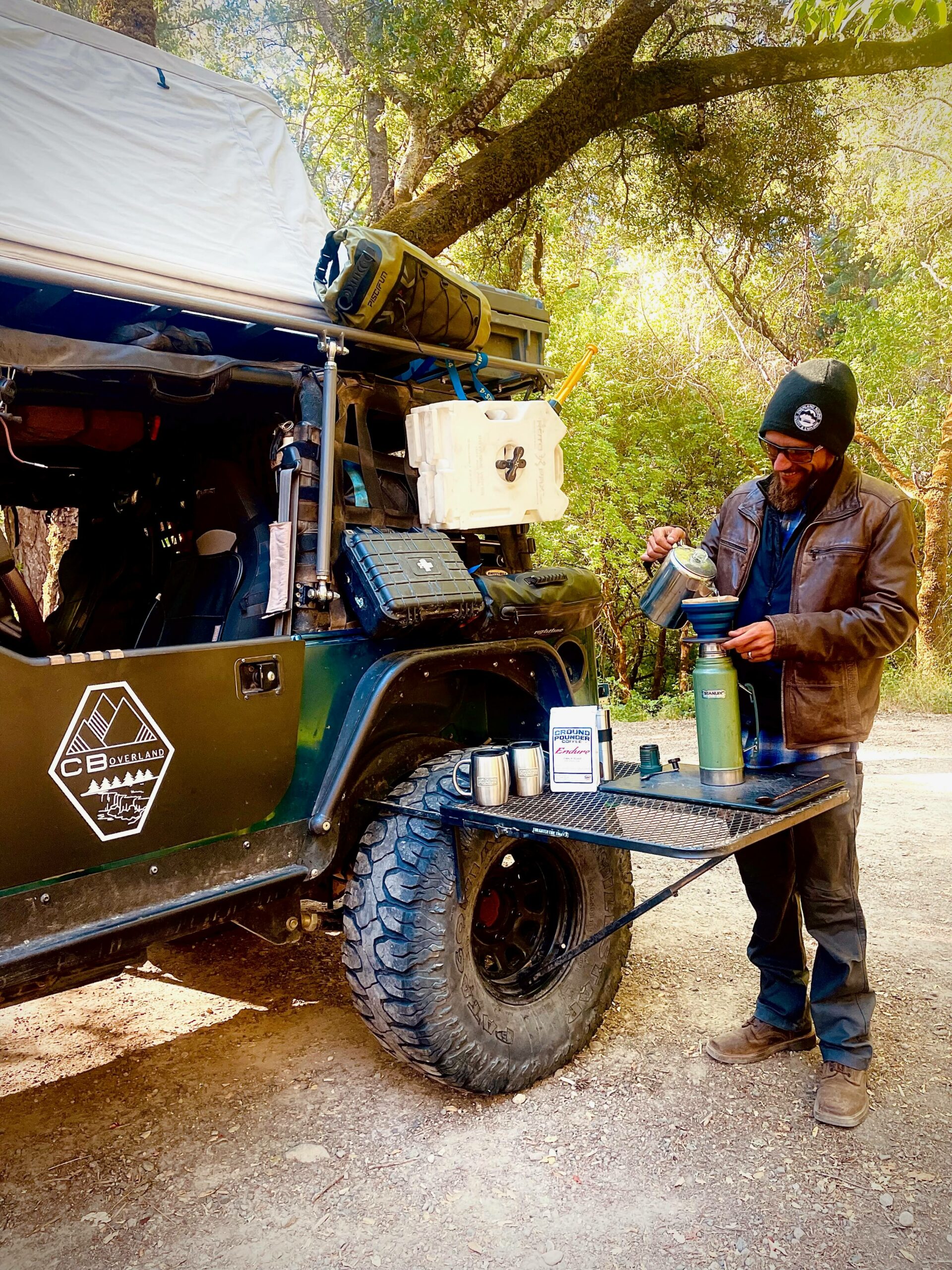 9AE4A02D-4098-4EB8-9833-19C34DDB24E4 Blake pours coffee next to his overlanding jeep.